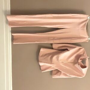 These Jaanuu designer scrubs are pink with gold zippers